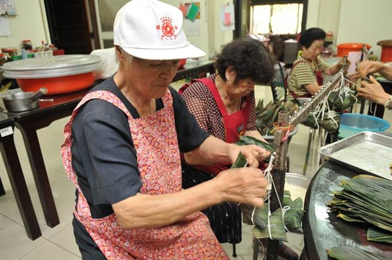 陳綢阿嬤高齡80許,直到現在她仍然帶領著志工們一起包粽。(廖肇祥攝)